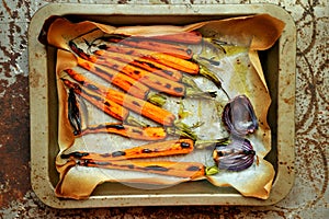 Organic meal with carrots and onion grilled in the oven