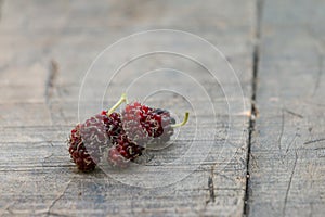 Organic mulberry on wooden background