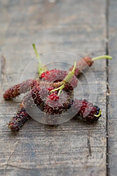 Organic mulberry on wooden background