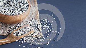 Organic natural sesame seeds wooden spoon. toasted sesame seeds. Raw, whole, unprocessed. Natural light. Selective focus