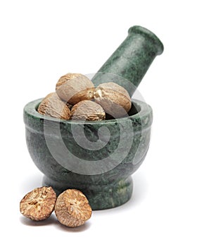 Organic Nutmeg Seed or Jaiphal (Myristica fragrans) on marble pestle.