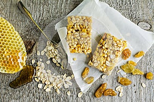 Organic oat cereal bars with honey and Golden raisins on a simple wooden background. Top view