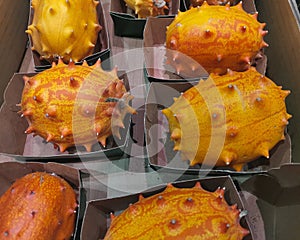 Organic Orange Kiwano Melon. Fresh Kiwanos or horned melon. African cucumis metuliferus, Fruits in boxes