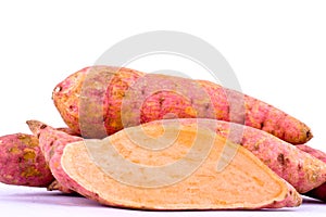 Organic orange sweet potato yam and half sweet potato on white background healthy fruit food isolated