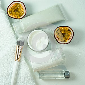 Organic passion fruit serum for skin care. Natural oil in a glass bottle, a container for white cream, natural cosmetics.