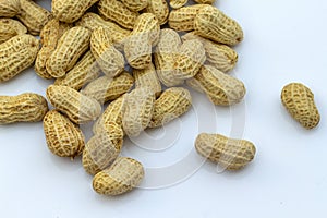 organic peanuts in shell, isolated on white background.