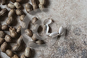 Organic peanuts on a yellow wooden background, close up