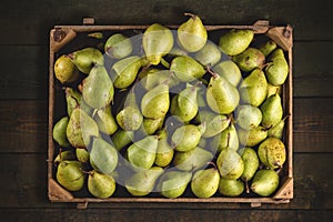 Organic pears in a wooden box from above