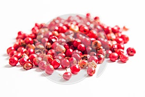 Organic peppercorn or pink pepper on white background