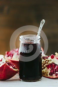 Organic pomegranate sauce on glass bottle with spoon