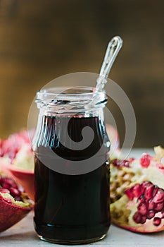 Organic pomegranate sauce on glass bottle with spoon