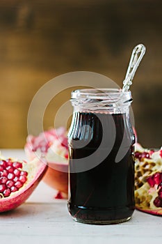 Organic pomegranate sauce on glass bottle with spoon