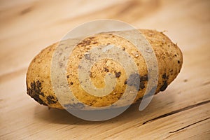 Organic potato on a wooden chopping board