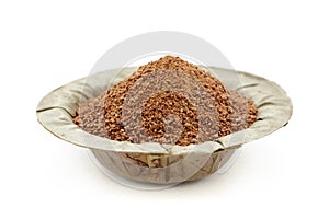 Organic powder of Indian Jujube (Ziziphus mauritiana) in a natural leaf plate.