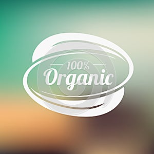 Organic product badge on blurred landscape. Vector illustration