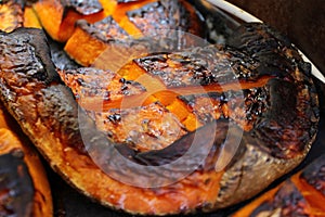 Organic Pumpkin slice baked for Halloween holiday. Colorful baked squash background. Pumpkin texture pattern. Sweet Grilled pumpki