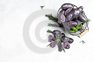 Organic purple sweet potato. Raw sweet potatoes or batatas. pomoea batatas. Batata potato, vegan food ingredient. banner, menu,