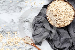 Organic Quick Oat Flakes in a Wooden Bowl