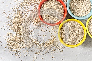 Organic quinua cereal in color bowl on white background