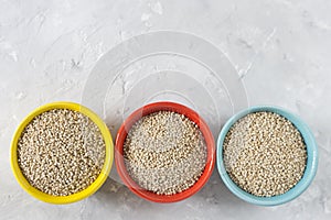 Organic quinua cereal in color bowl on white background