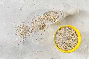 Organic quinua cereal in color bowl on white background