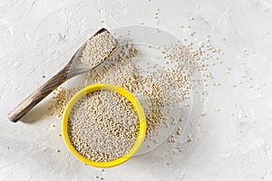 Organic quinua cereal in color bowl on white background photo