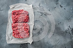 Organic Raw Grass Fed Ground Beef, on gray background, top view flat lay  with copy space for text