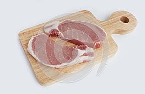 Organic raw pork meat on wooden chopping board on white background.Top view.