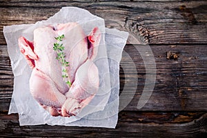 Organic raw whole chicken on wooden background
