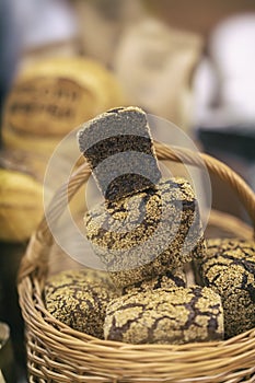 Organic rye bread with cereals in a basket, baked in the rustic oven