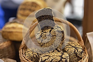 Organic rye bread with cereals in a basket close-up, baked in the rustic oven