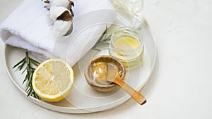 Organic skincare ingredients with towels and manuka honey, natural treatments ingredients with lemon, honey, balm salve, rosemary photo