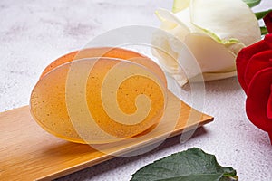 Organic soaps homemade with ingredients are honey on a bamboo plate.