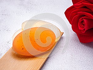 Organic soaps homemade with ingredients are honey on a bamboo plate with a gray stone background