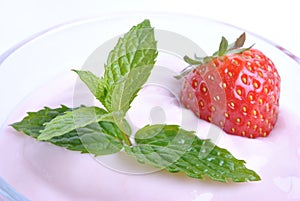 Organic strawberry in yogurt and mint