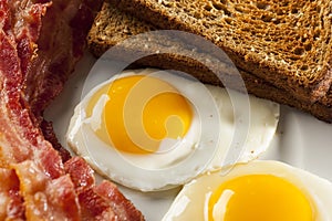 Organic Sunnyside up Egg with toast and bacon