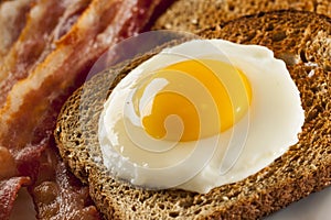 Organic Sunnyside up Egg with toast and bacon