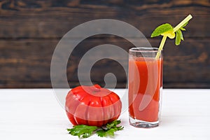 Organic tomato with glass of vegetable juice