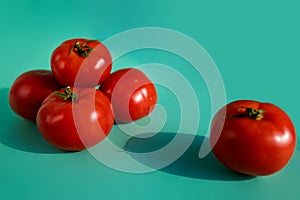Organic Tomatoes Knolled On Blue Background, Organic Vegetable Food.