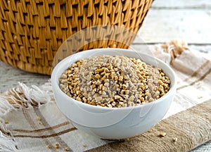 Organic Uncooked Steel Cut Oats in bowl on napkin.  Also know as pinhead oats and Irish oats.