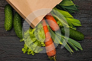 Organic vegetables. bag of products on a dark wooden background