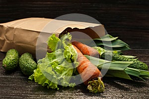 Organic vegetables. bag of products on a dark wooden background