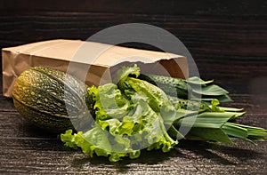 Organic vegetables. bag of products on a dark wooden background