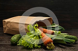 Organic vegetables. bag of products on a dark wooden background