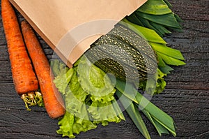 Organic vegetables. bag of products on a dark wooden background