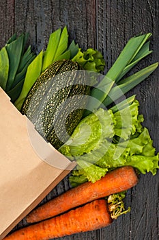 Organic vegetables. bag of products on a dark wooden background