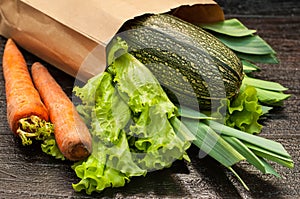 Organic vegetables. bag of products on a dark wooden background