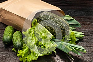 Organic vegetables. bag of products on a dark wooden background
