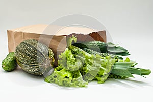 Organic vegetables. bag of products on a white wooden background. Crop agronomist from the garden