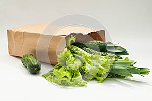 Organic vegetables. bag of products on a white wooden background. Crop agronomist from the garden